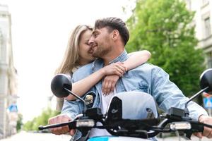 Stylish couple with a motorcycle on a city street photo