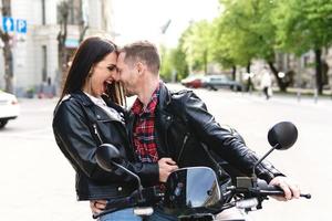 Stylish couple with a motorcycle on a city street photo