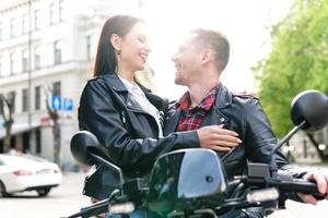 Stylish couple with a motorcycle on a city street photo