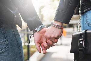 Young loving couple holding hands photo