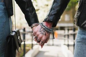 Young loving couple holding hands during a date outdoors photo