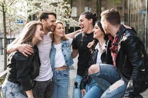 Group of best friends are having fun outdoors. Young people are happy to see each other during a meeting. photo