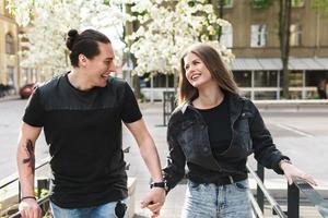 Happy laughing couple having fun during their date on a city street photo