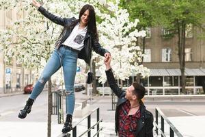 Beautiful couple in love wearing leather jackets during a date on a city street photo