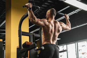 Muscular bodybuilder during his workout in the gym photo