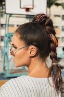 Young woman with a trendy hairstyle wearing sunglasses photo