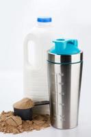 Metal protein shaker and big bottle of milk photo