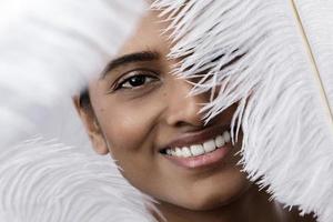 Young and sensual Indian woman with a soft ostrich feather photo