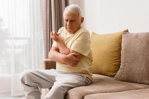 Senior man suffering from pain in his elbow photo