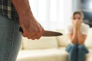 Man assaulting his victim with a knife. Domestic violence or serial killing concepts.