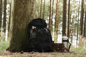 Traveler's backpack with supplies on the ground photo