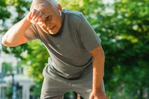 Exhausted elderly man after his jogging workout photo