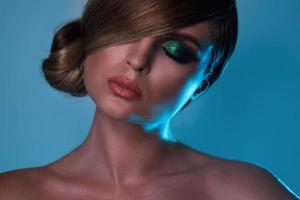 Model in stylish image with sleek hair covering one eye photo