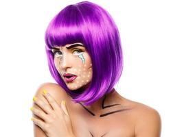 Model in creative image with pop art makeup photo