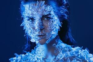 Female face covered with a lot small pieces of glass or ice photo