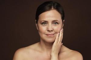 Beautiful middle aged woman with clean wrinkled skin photo