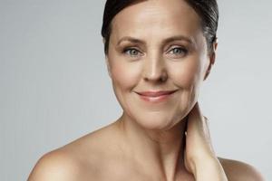 Beautiful middle aged woman with clean wrinkled skin photo