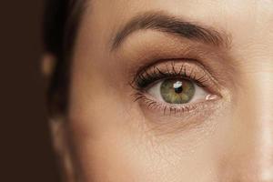 Aged female eye with wrinkled skin photo