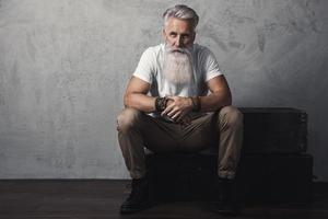 Handsome bearded senior man posing in studio photo