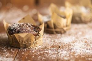 Cooking tasty chocolate muffins in powdered sugar