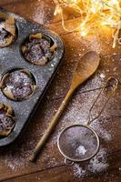 Baking tin with a tasty chocolate muffins photo