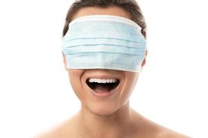 Happy smiling woman wearing mask over her eyes photo