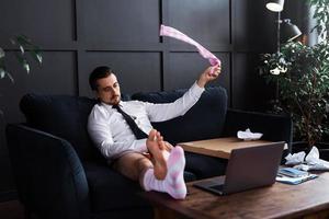 Lazy businessman without pants is working from home photo