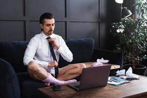 Businessman without pants during job interview or online meeting during distant work from home photo