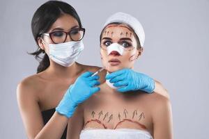 Conceptual image of two women plastic surgery victims photo