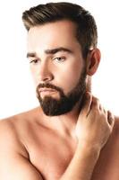 Handsome bearded man with a smooth skin on white background photo