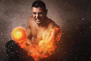 Bodybuilder with burning arm during bicep exercise with the dumbbell photo