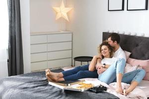 Young and happy couple relaxing at home photo