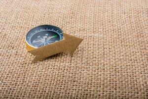 Compass and  paper arrow on a canvas