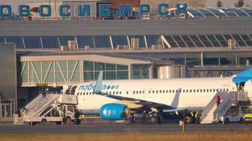 NOVOSIBIRSK, RUSSIAN FEDERATION MAY 10, 2021 - Pobeda Airlines boarding passengers for a flight at Tolmachevo airport, Novosibirsk OVB. Pobeda Russian low cost airline video