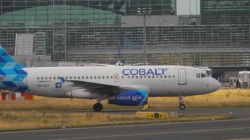 FRANKFURT AM MAIN, GERMANY JULY 18, 2017 - Passenger commercial aircraft of Cobalt Air taxi to the terminal after landing at Fraport International Airport, Frankfurt, Germany FRA video