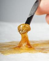 golden wax terp sauce, cannabis thc dab resin on paper photo