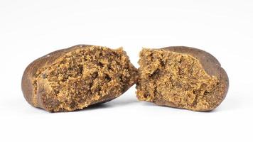 brown broken piece of cannabis concentrate hashish isolated on white background, hash weed photo