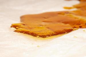 a pieces of cannabis wax closeup. concentrate dab stone with high thc photo