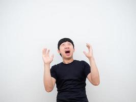 Asian man feeling shocked show hand and looking up at space white background photo