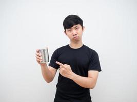 Asian man serious emotion point finger at can in hand photo