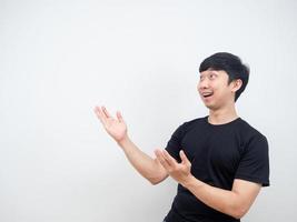 Asian man cheerful pointing hand at side present product concept copy space photo