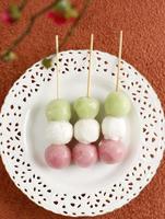 Skewered Sanshoku Dango on White Plate. photo