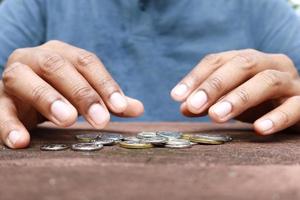Close up of man hand counting coins photo