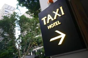 taxi stand sign on black in singapore photo