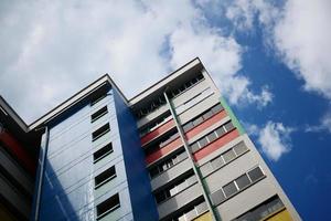 low angle view of signapore residential buildings against blue sky photo