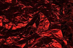 Crumpled plastic wrap texture in red color gradient for background and photo overlay effect