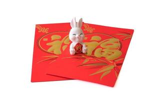 Chinese New Year of the rabbit festival concept. Rabbit on red envelopes isolated on white background. Happy New Year Chinese Rabbit 2023. Chinese character fu which stands for luck. photo