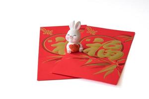 Chinese New Year of the rabbit festival concept. Rabbit on red envelopes isolated on white background. Happy New Year Chinese Rabbit 2023. Chinese character fu which stands for luck. photo