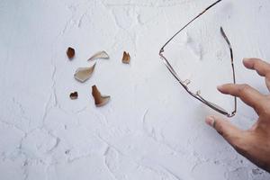 broken eye glass on table with copy space photo