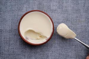 fresh yogurt in a bowl on table photo